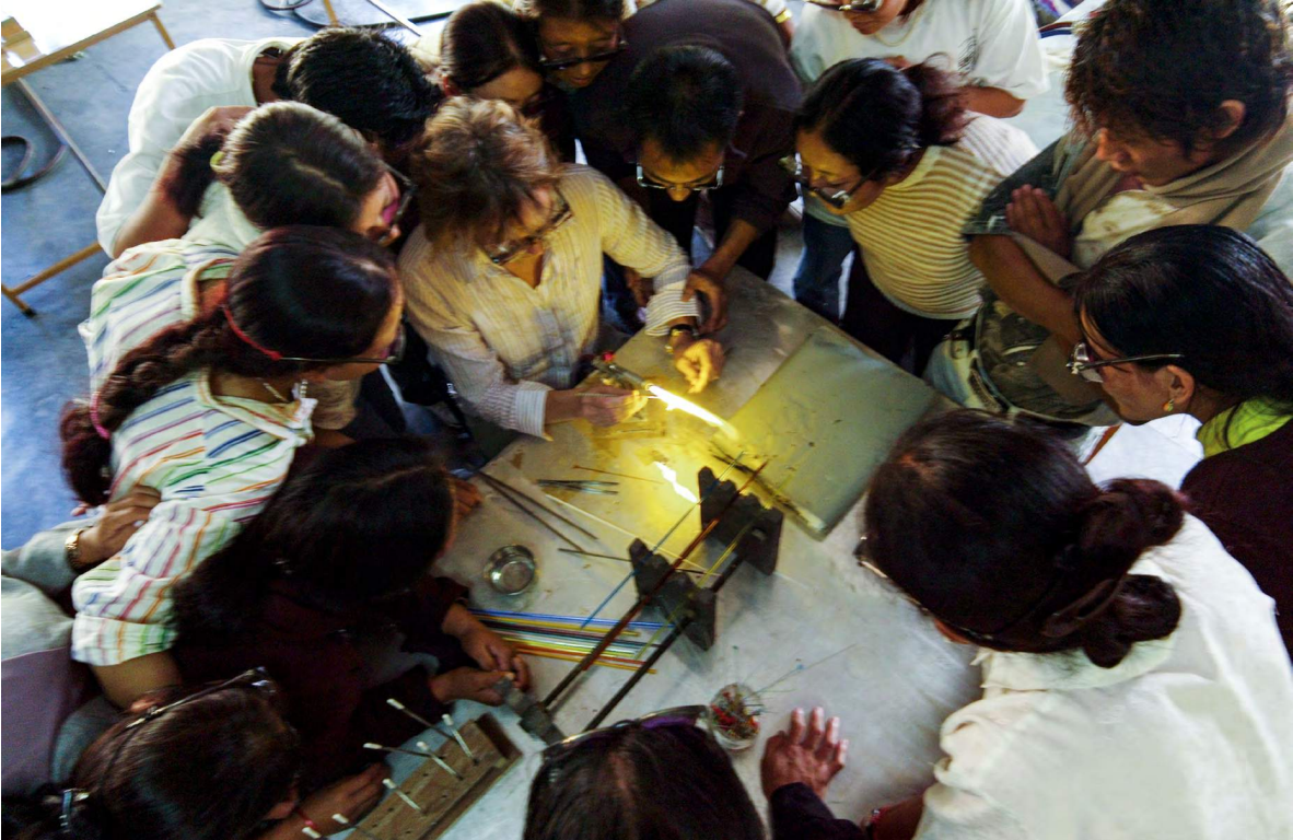 Lise showing how to make glass beads